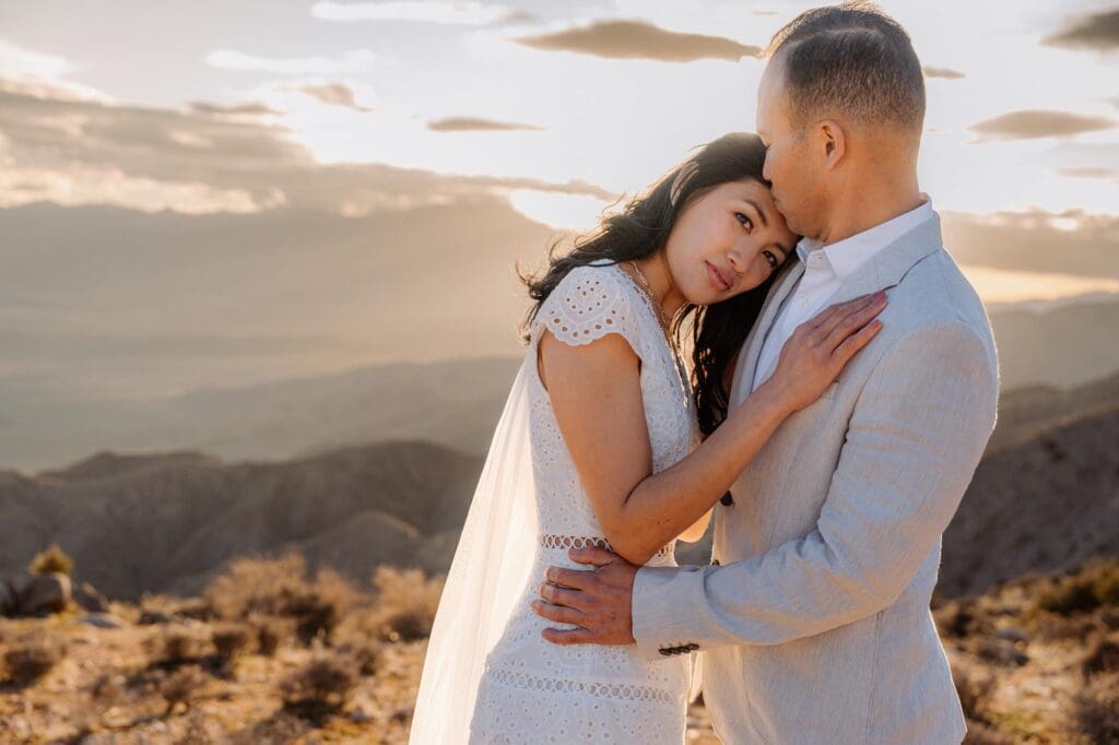 Eloping in Joshua Tree during golden hour at Keys View Couple eloping in Joshua Tree cuddling at golden hour sunset at Keys View