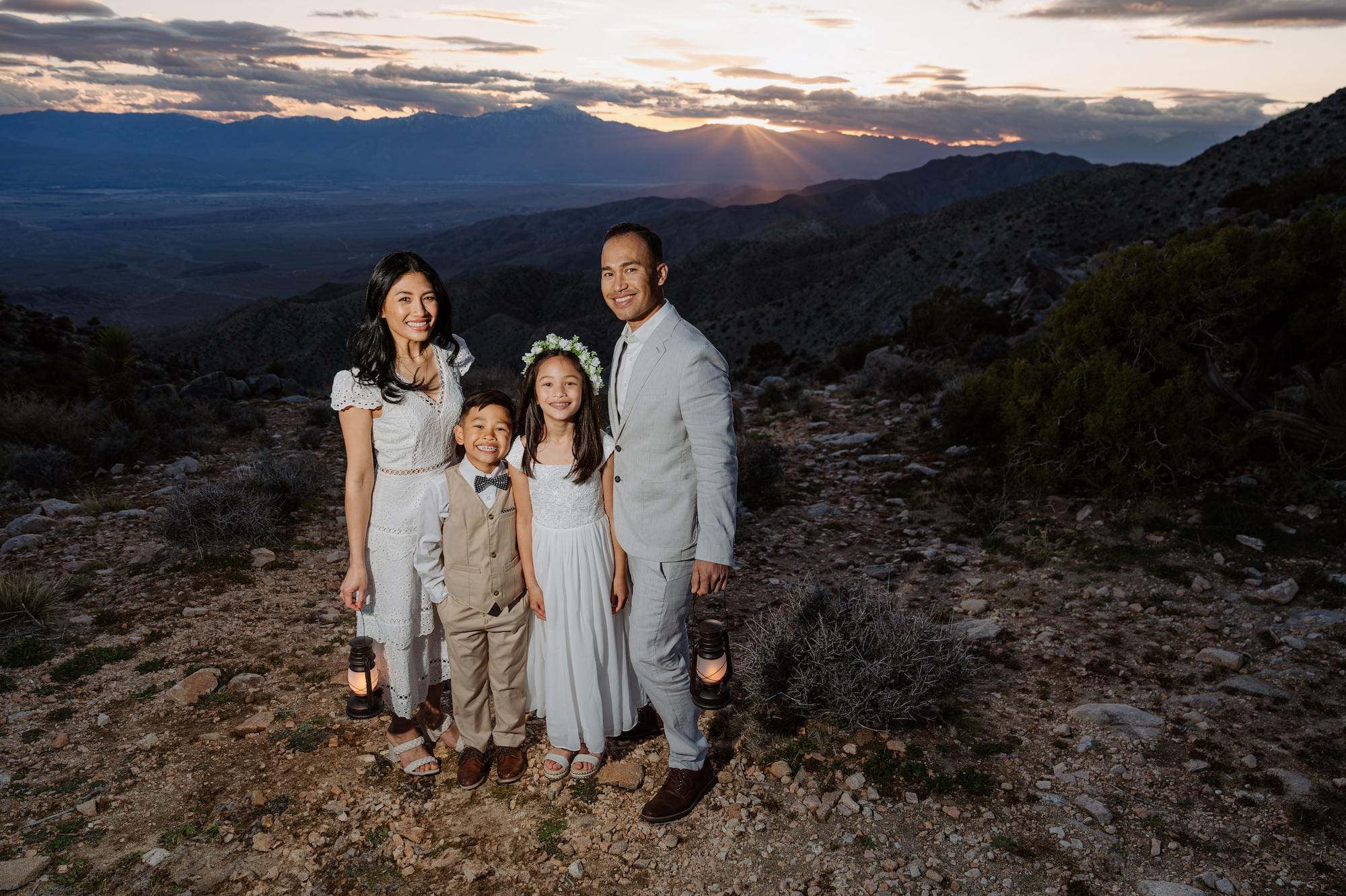 Family with kids during a Joshua Tree elopement with lanterns at sunset on Keys View