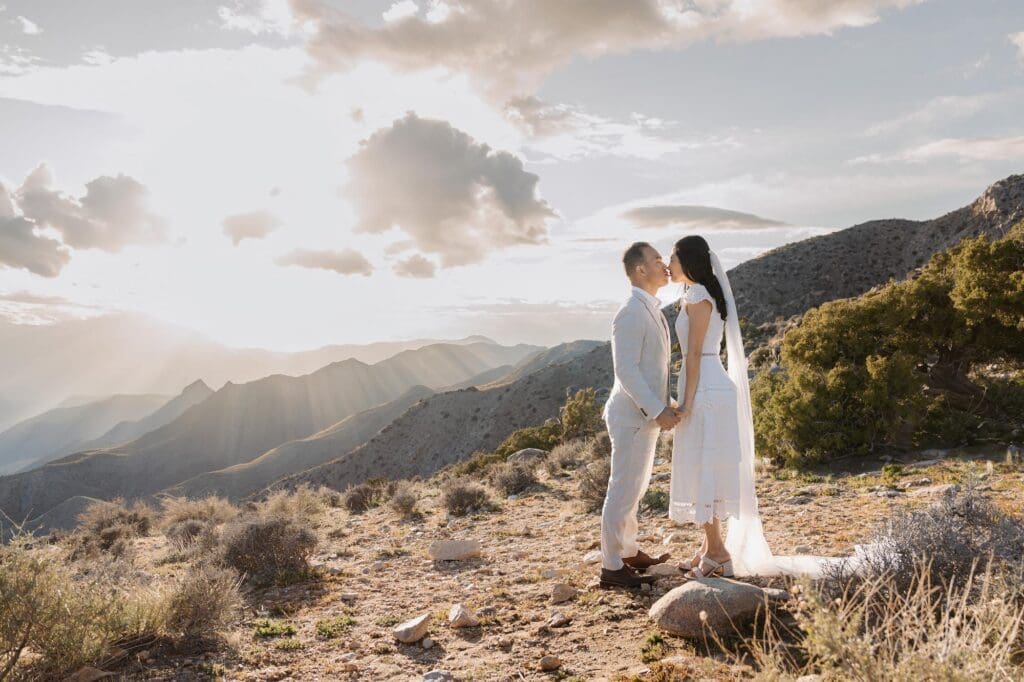 Golden hour kiss while eloping in Joshua Tree Bride and groom kiss during golden hour at Keys View while eloping in Joshua.