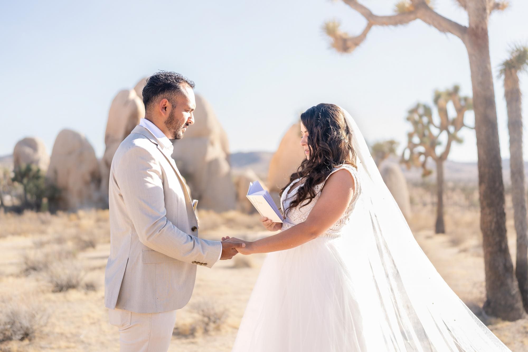 Bride and groom exchanging vows during their Joshua Tree elopement ceremony