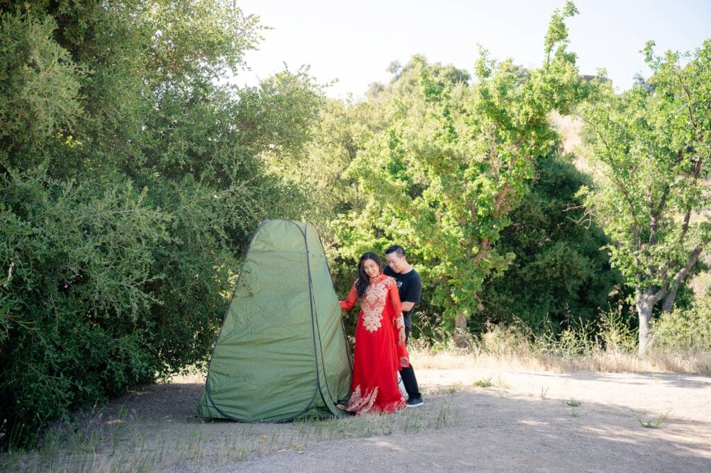 Bride changing into red Ao Dai using a portable privacy tent before her Malibu elopement