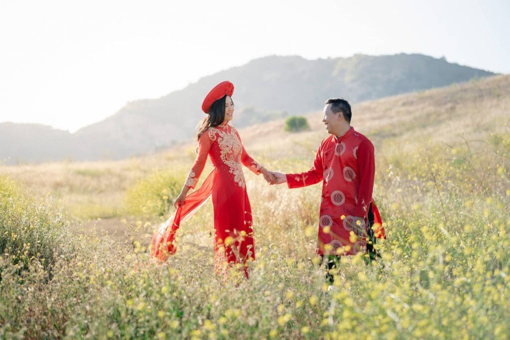 Vietnamese bride and groom holding hands in a wildflower field during their Malibu elopement
