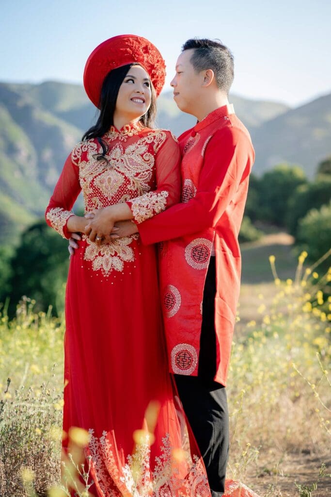 Close-up portrait of Vietnamese couple wearing red and gold Ao Dai during their Malibu elopement