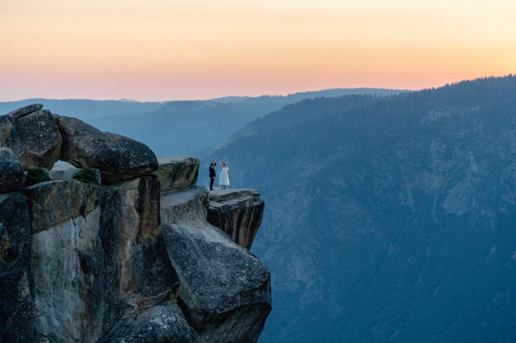 Yosemite Elopement at Taft Point – Morgan & Jesse Couple standing on the cliffs of Taft Point during their Yosemite elopement at sunset